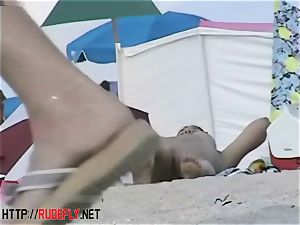 Beach cuties hang out nude below the sun